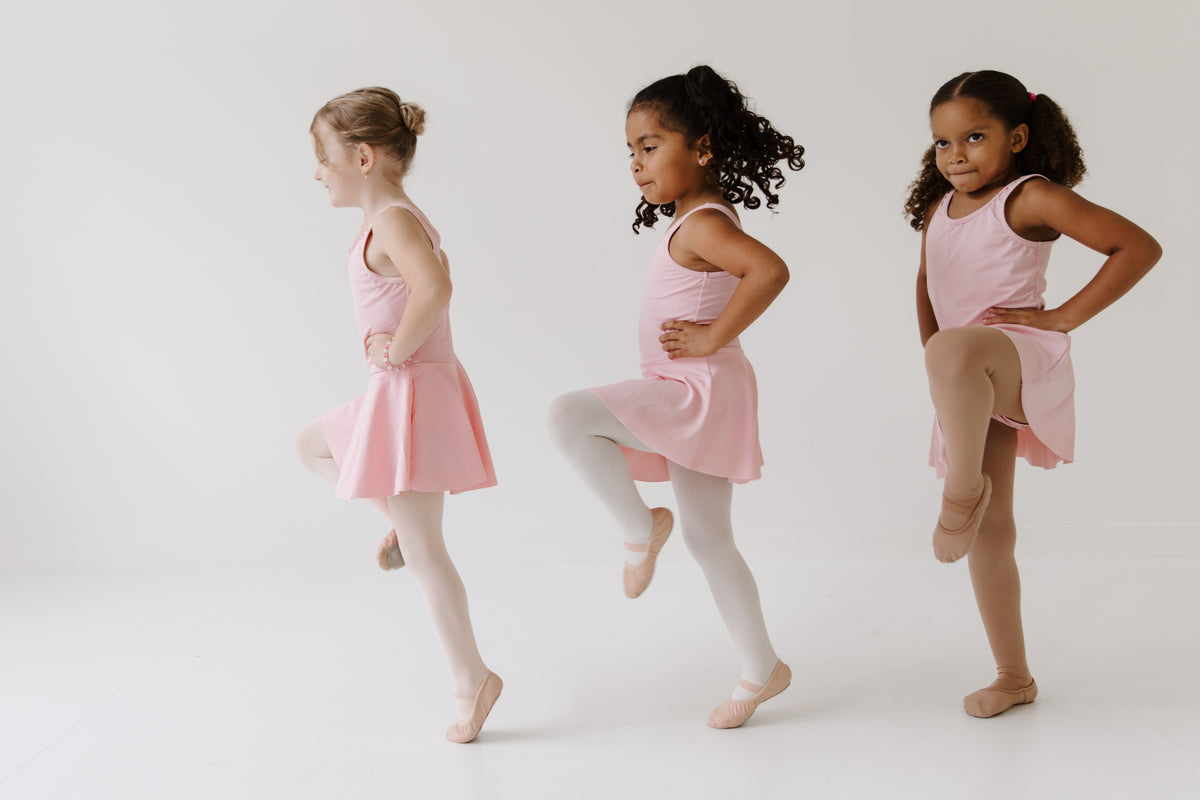Young dancers in pink ballet shoes and leotards